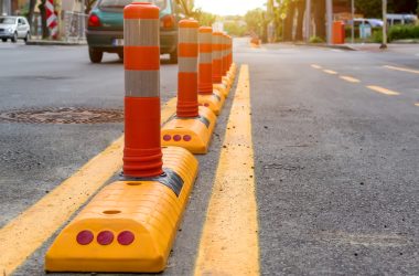 Columns,With,A,Reflective,Layer,And,Yellow,Road,Marking,Separates Columns,With,A,Reflective,Layer,And,Yellow,Road,Marking,Separates